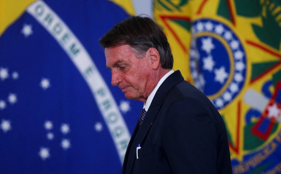 FILE PHOTO: Brazil's President Jair Bolsonaro listens to Brazil's Environment Minister Joaquim Leite during an event to promote the production and sustainable use of Biomethane at the Planalto Palace in Brasilia, Brazil March 21, 2022.REUTERS/Adriano Mach