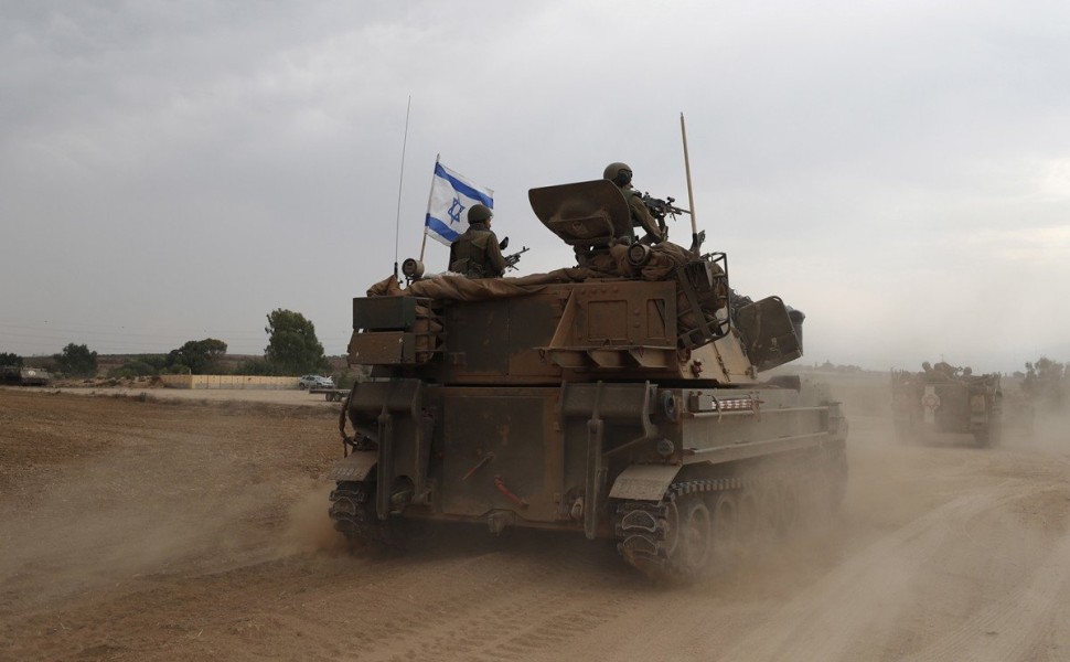 epaselect epa10909875 Israeli soldiers on military vehicles maneuver at an area along the border with Gaza, southern Israel, 09 October 2023. Israeli chief military spokesperson Rear-Admiral Daniel Hagari said on 09 October that the country had drafted a 