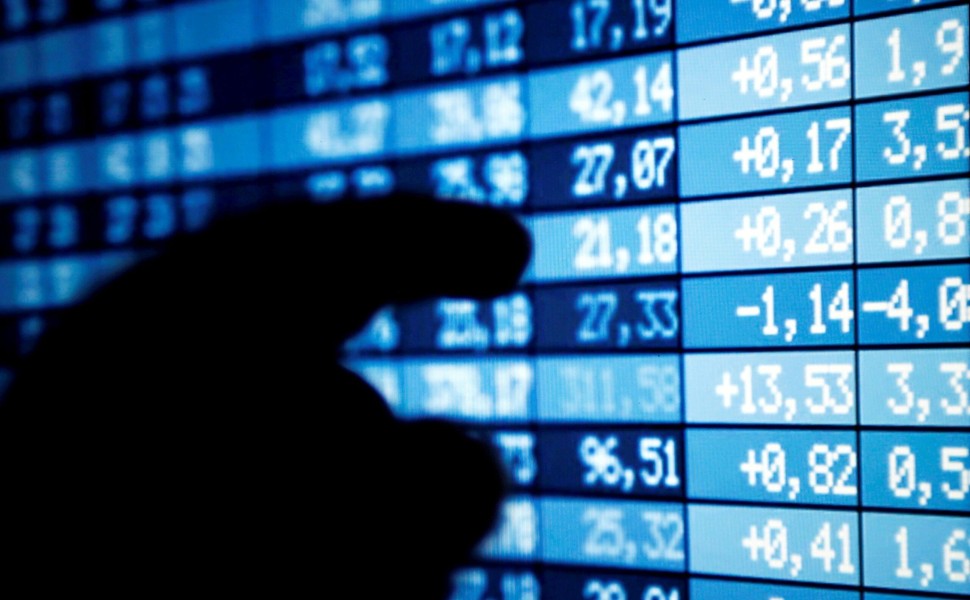 FILE PHOTO: A man points a computer screen showing stock information in this illustration photo taken in Bordeaux, France, March 30, 2016. REUTERS/Regis Duvignau/File Photo