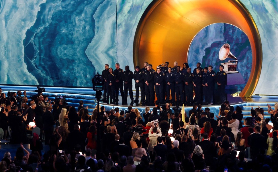 Members of the Los Angeles County Fire Department stand onstage during the 67th Annual Grammy Awards - Reuters