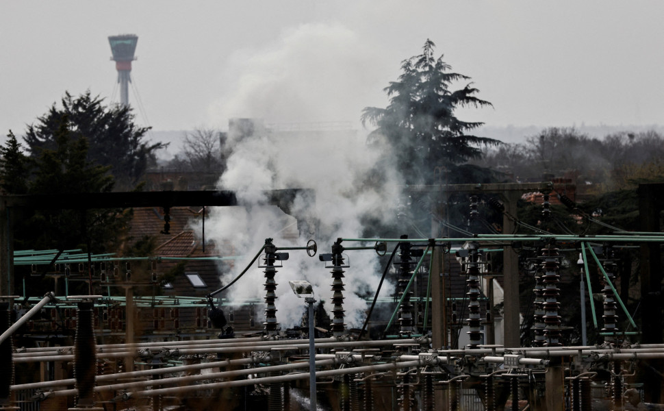 Καπνός υψώνεται από την περιοχή ενός ηλεκτρικού υποσταθμού, με τον πύργο ελέγχου του Heathrow στο βάθος, μετά από πυρκαγιά που προκάλεσε διακοπή ρεύματος στο αεροδρόμιο. Πηγή: Reuters