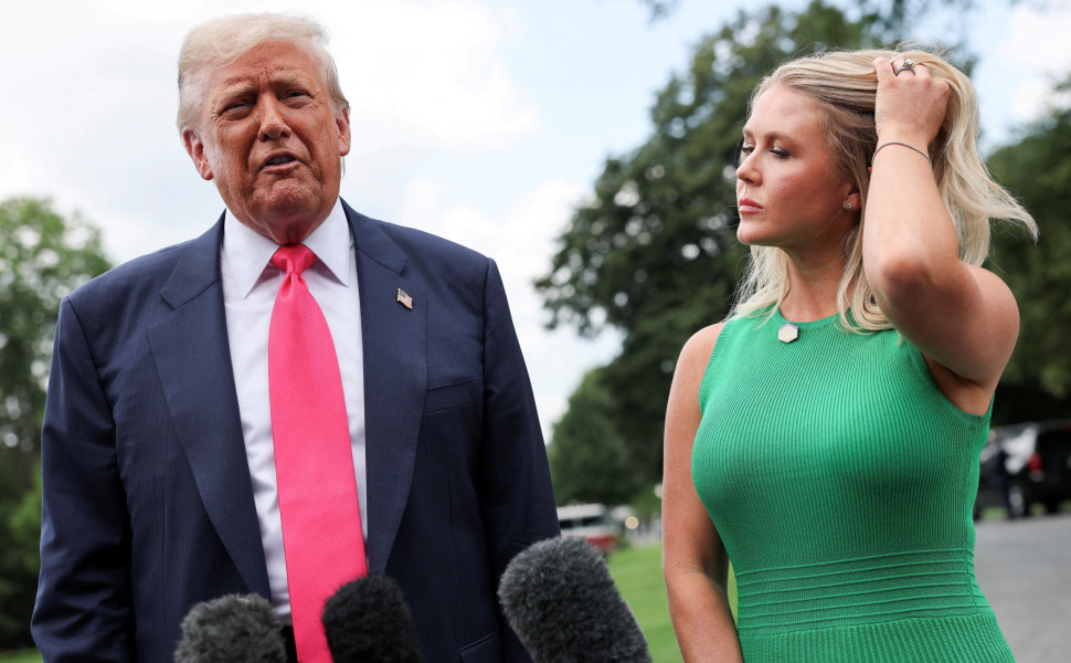 U.S. President Donald Trump speaks with reporters, while White House Press Secretary Karoline Leavitt stands next to him, as he departs for travel to Pennsylvania from the South Lawn at the White House in Washington, D.C. U.S., July 15, 2025. REUTERS/Jona